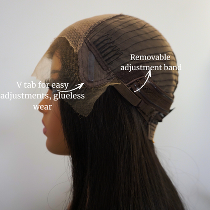Wig with removable adjustment band and V tab for easy adjustments on a neutral background